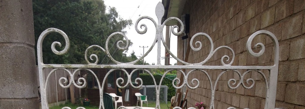 Decorative metal garden gate with scrollwork