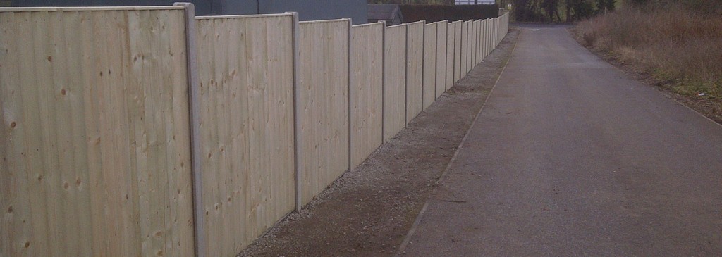Close-board timber fence following a road boundary