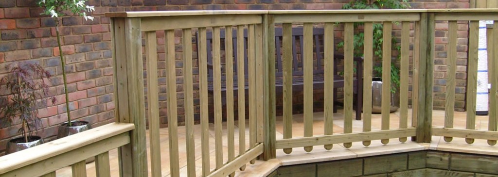 Timber deck balustrade beside a brick garden wall