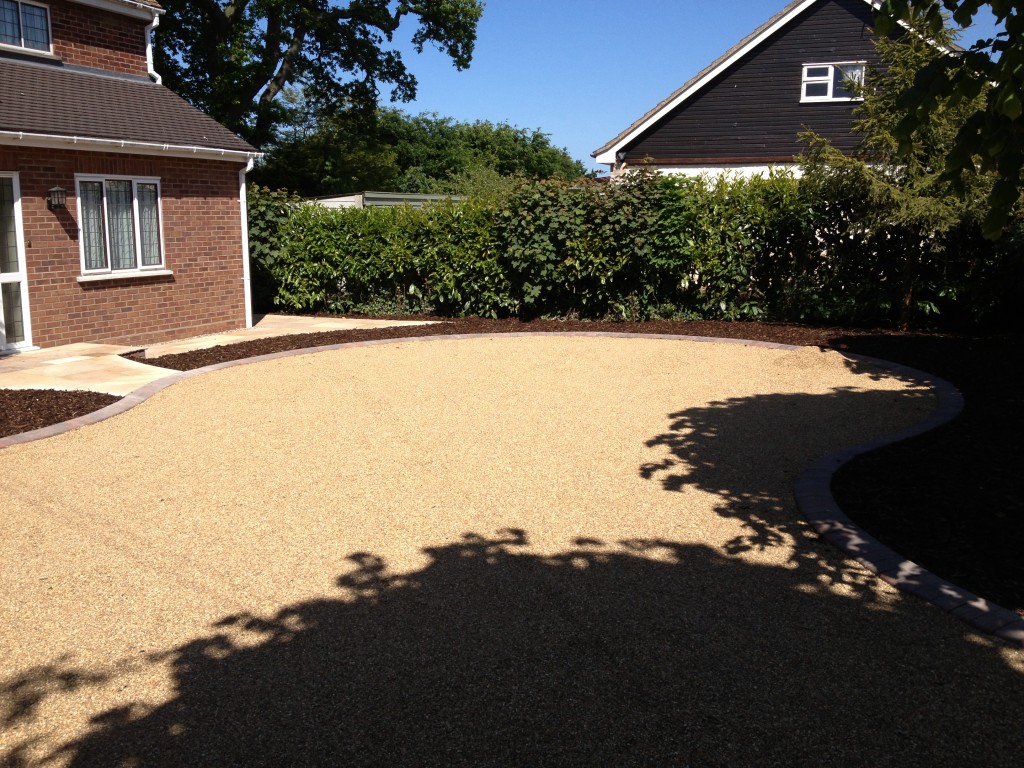 Golden gravel driveway beside a bungalow