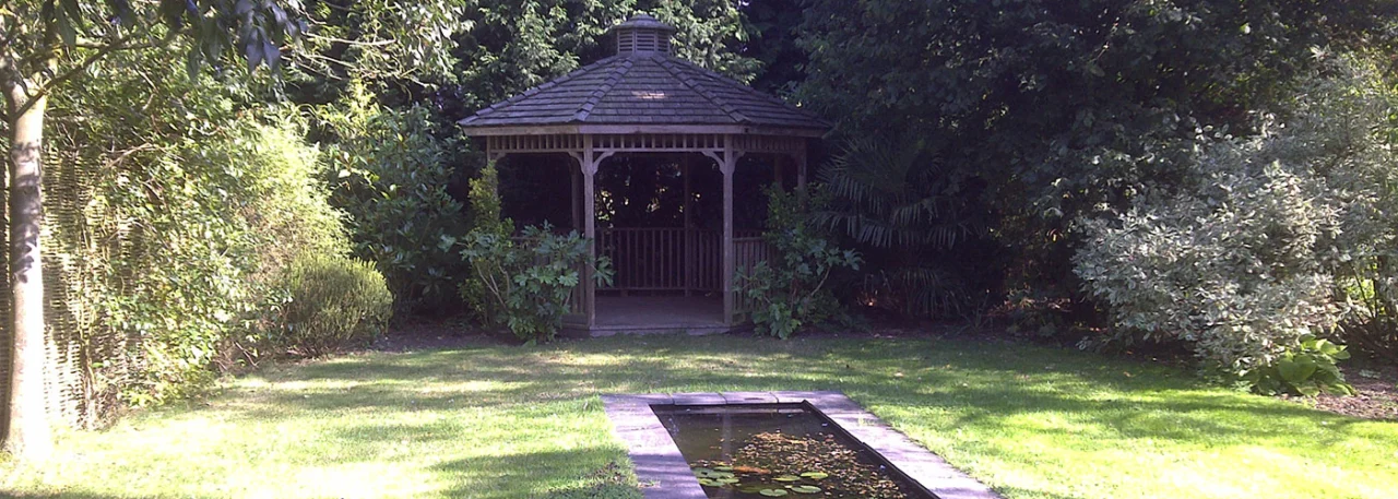 Garden summerhouse beyond a lawn and path