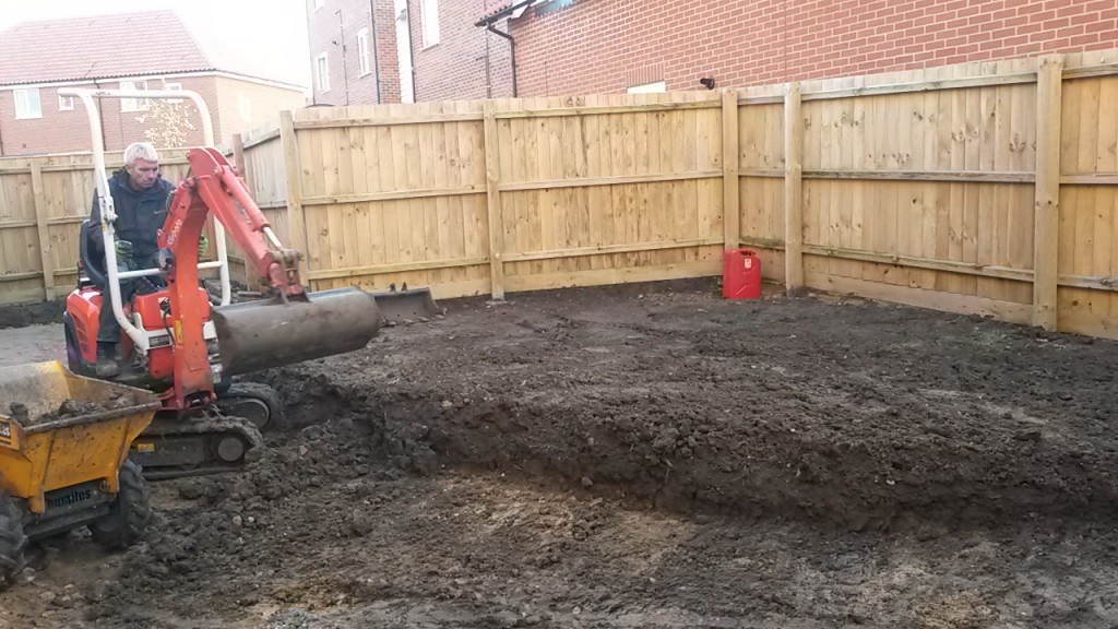 Excavator preparing a raised patio area