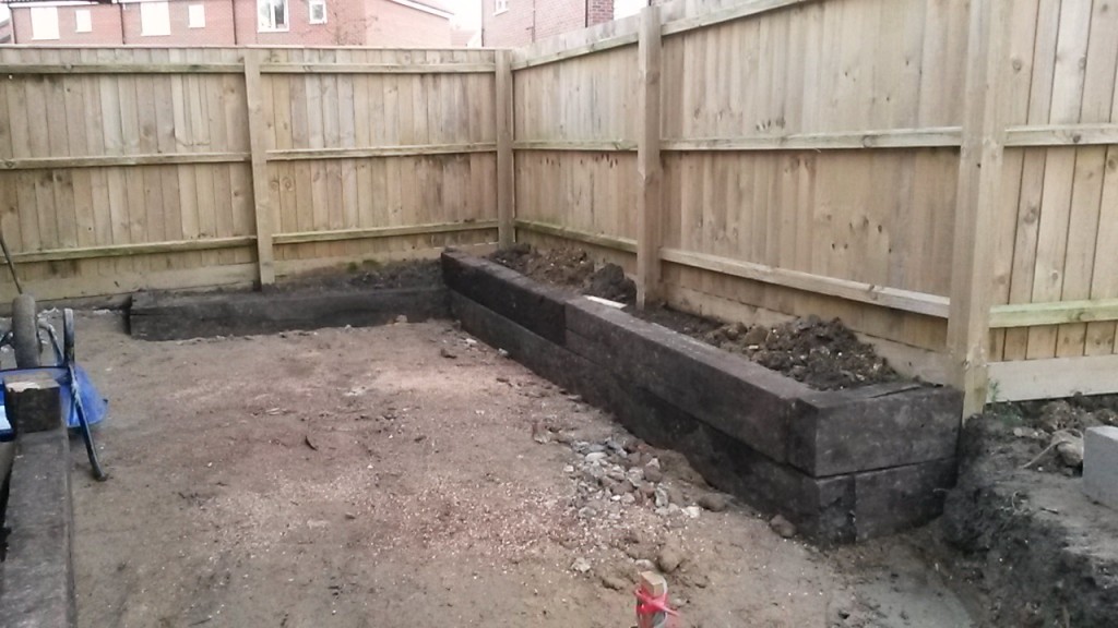 Timber sleeper retaining wall under construction