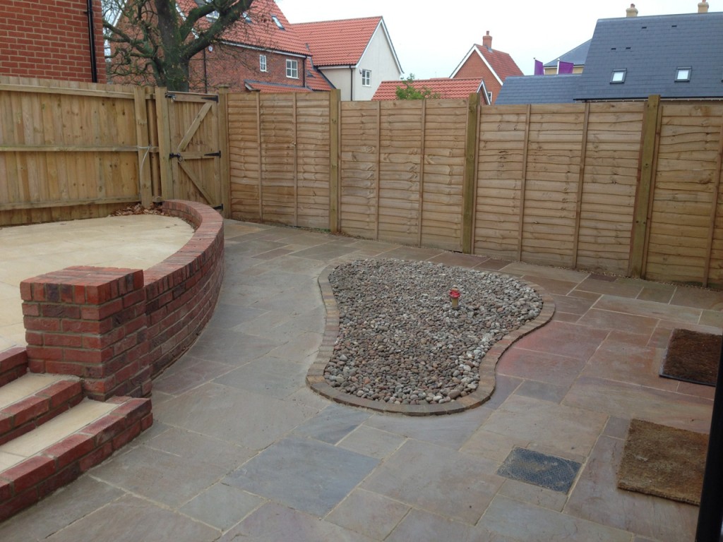 Completed paving with curved brick steps and a gravel inset