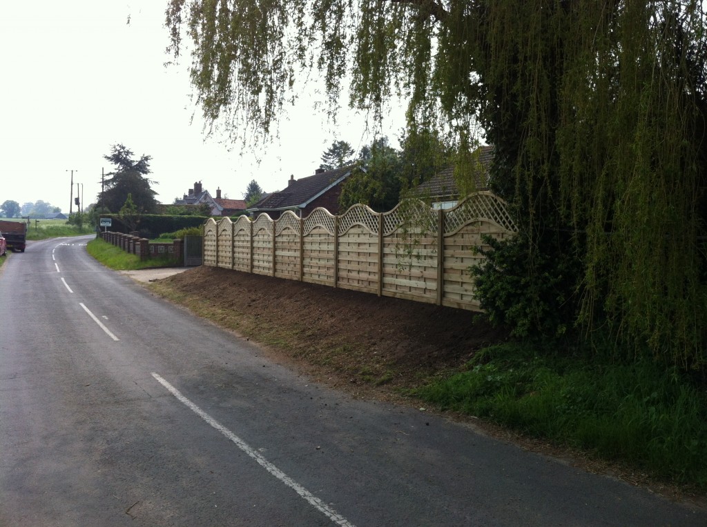 Timber boundary fencing with curved trellis tops