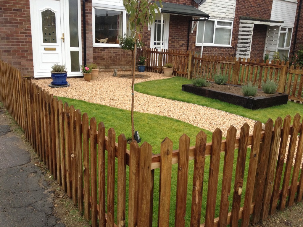 Completed front garden enclosed by timber picket fencing