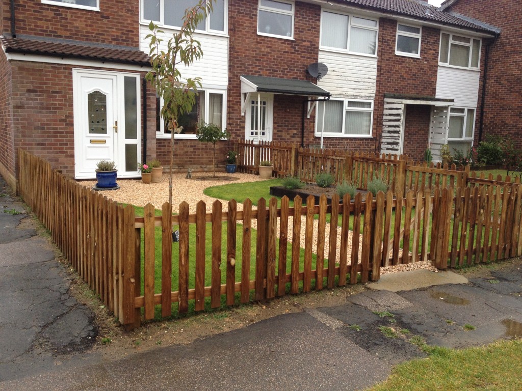 Completed front garden enclosed by timber picket fencing