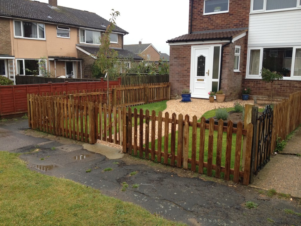 Completed front garden enclosed by timber picket fencing