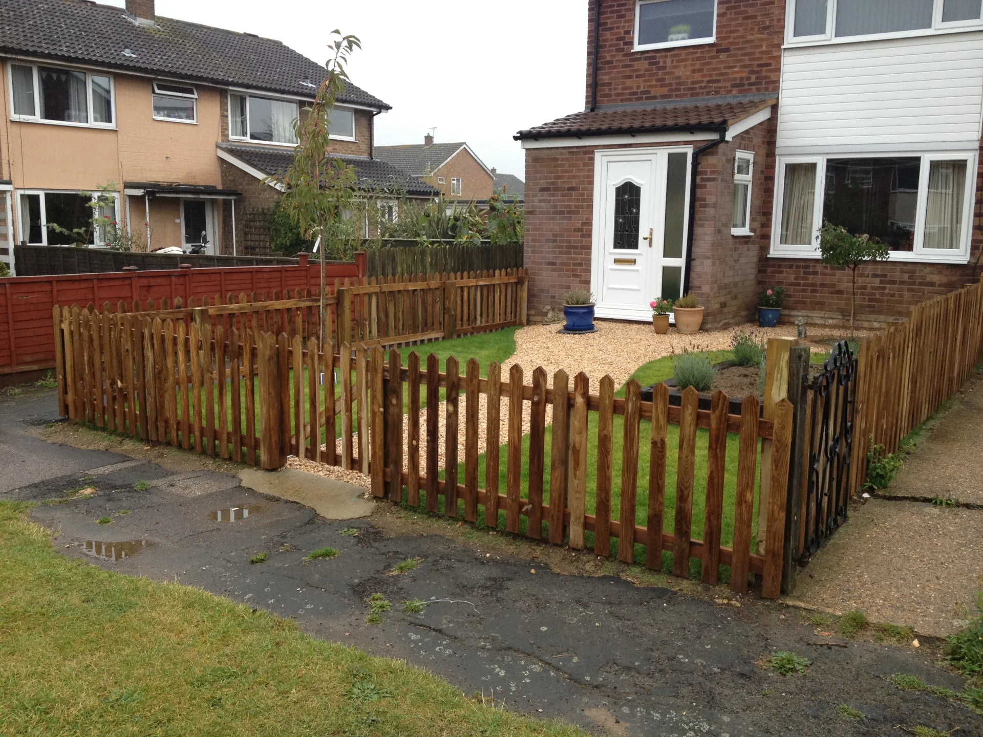 Completed front garden enclosed by timber picket fencing
