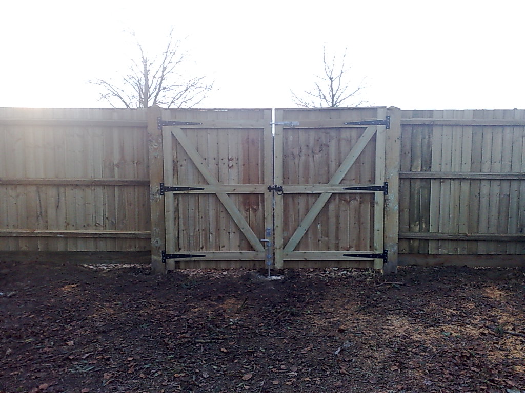 Double timber access gates in a close-board fence