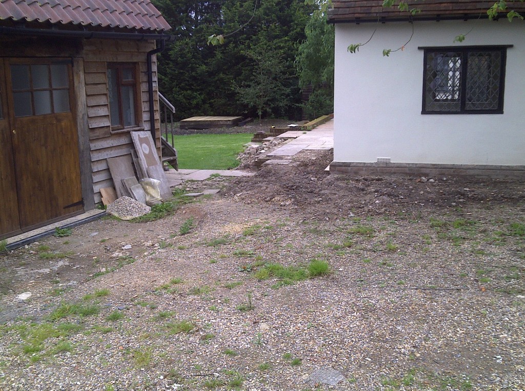 Uneven courtyard surface before landscaping