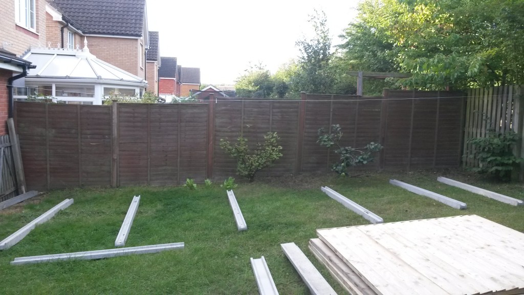 Fence posts laid out before garden fence installation