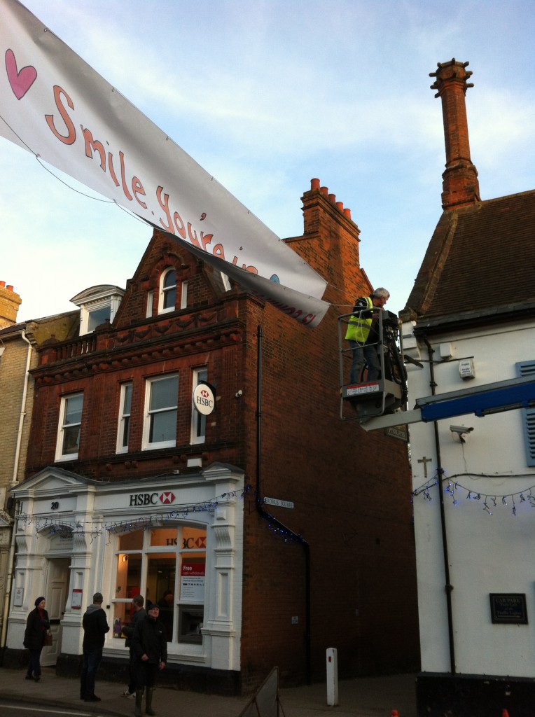 Elevated access platform installing a banner above a street