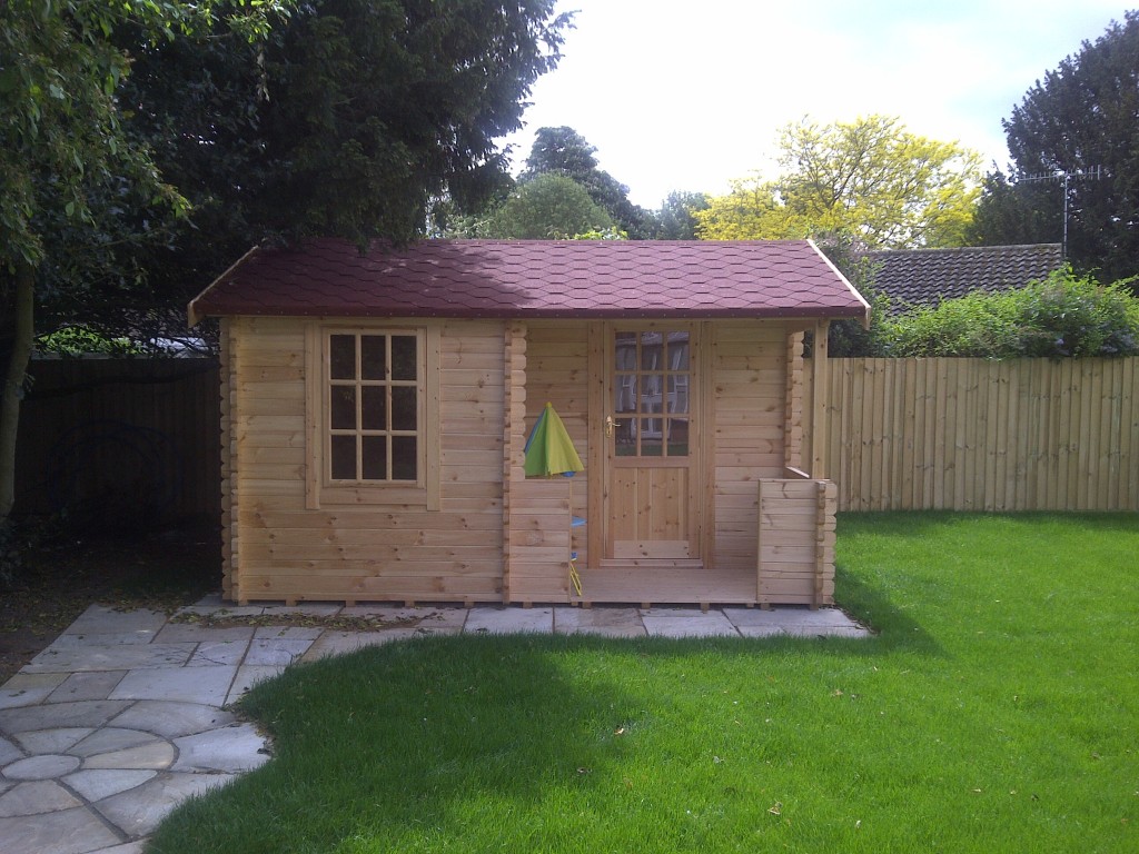 Timber garden playhouse with a covered entrance