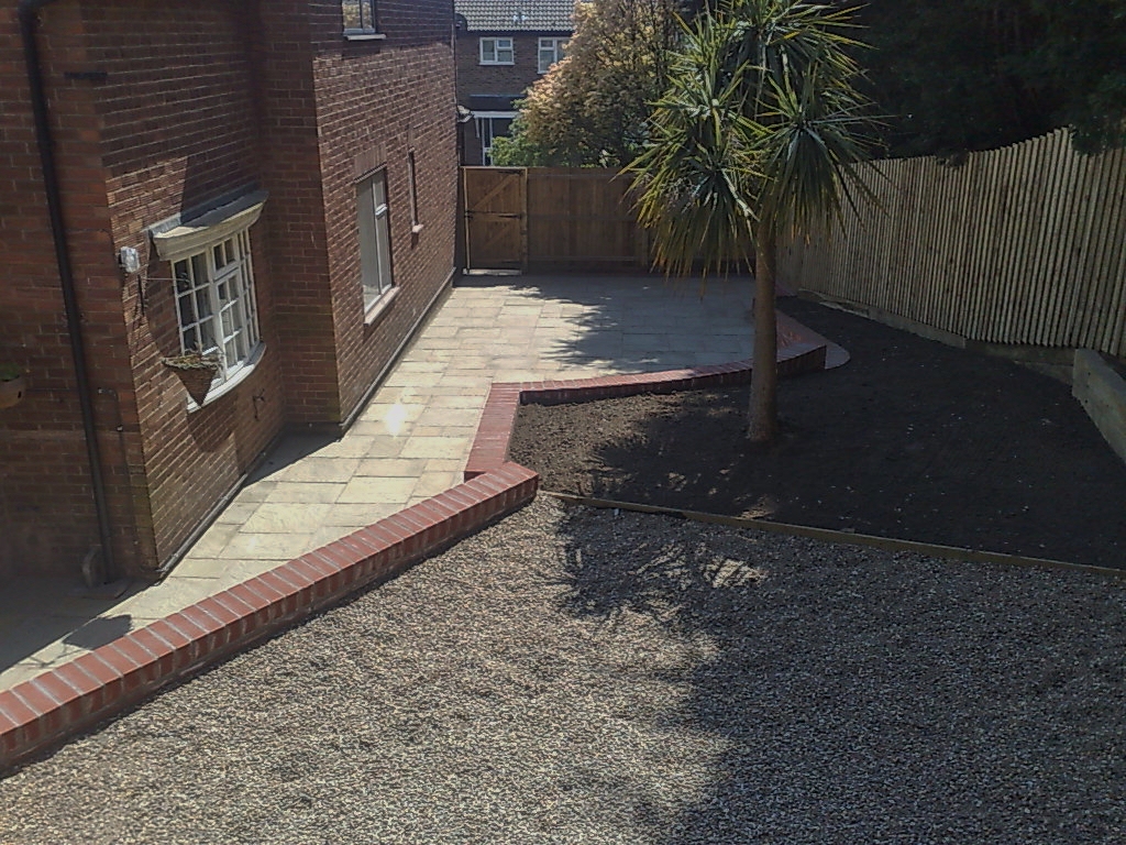 Completed stone patio with brick retaining walls
