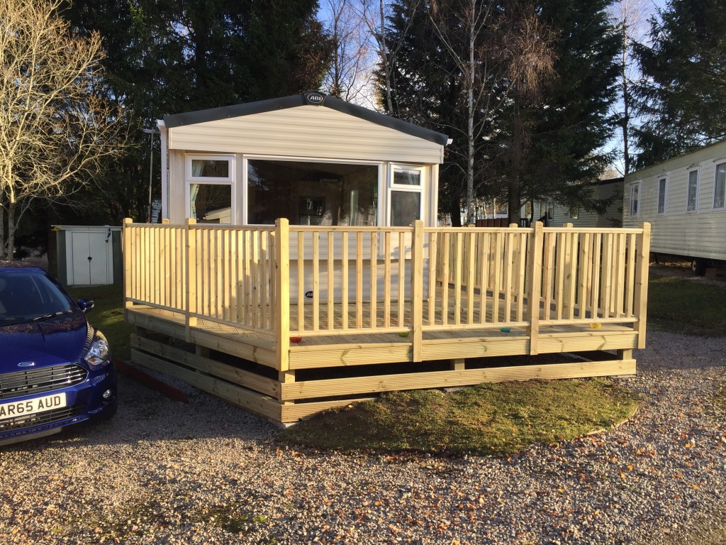 Completed timber decking and balustrade around a static caravan