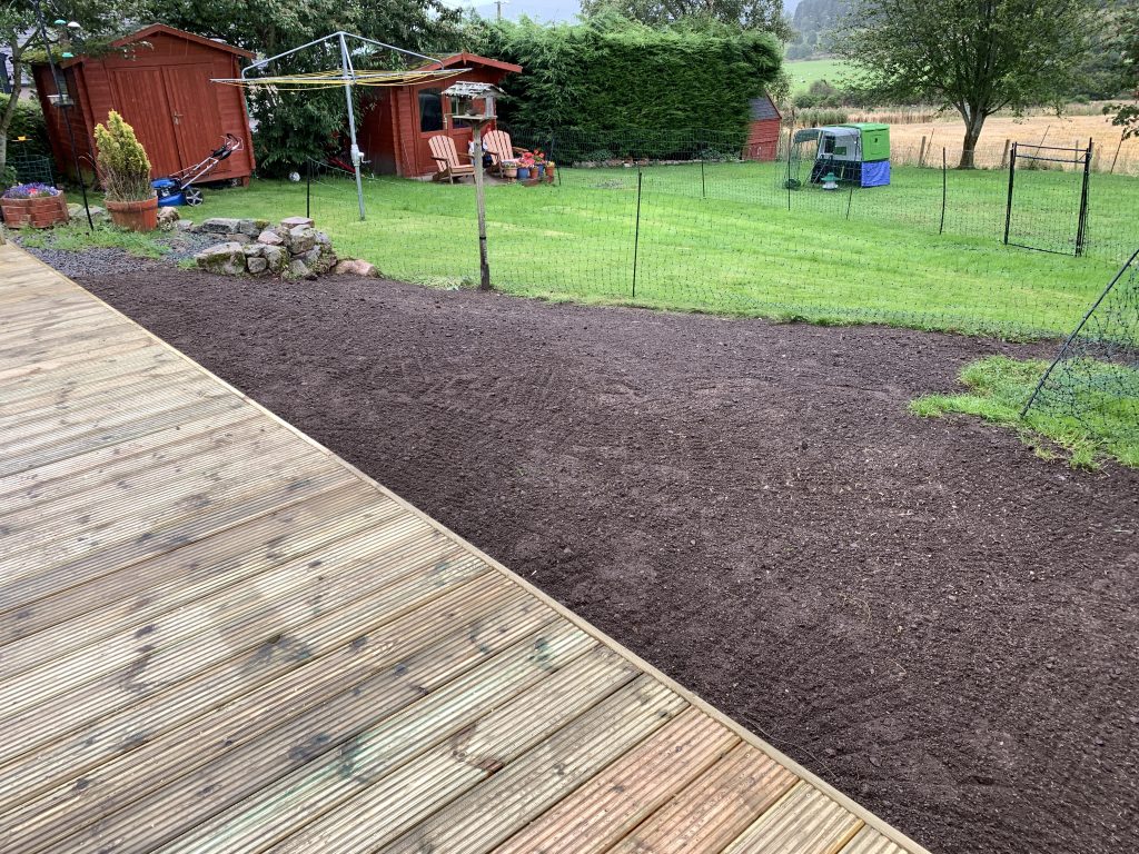 Completed timber garden deck with boundary fencing